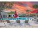 Community pool with plenty of seating and palm trees at 16436 Parable Way, Winter Garden, FL 34787