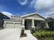 Charming single-Gathering home featuring a two-car garage, welcoming front porch, and beautifully landscaped front yard at 16436 Parable Way, Winter Garden, FL 34787