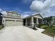 Charming single-Gathering home featuring a two-car garage, welcoming front porch, and beautifully landscaped front yard at 16436 Parable Way, Winter Garden, FL 34787