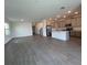 Spacious living area with wood-look tile flooring, abundant natural light, and an open floor plan at 16436 Parable Way, Winter Garden, FL 34787