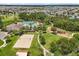 Aerial view of the community amenities, featuring a clubhouse, pool, and sand volleyball court at 1693 Barberry Dr, Kissimmee, FL 34744