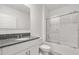Clean bathroom featuring a vanity with granite countertop and a glass-enclosed shower tub at 1693 Barberry Dr, Kissimmee, FL 34744