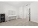 Bright bedroom features neutral carpet, a makeup vanity with lighted mirror and ensuite bathroom at 1693 Barberry Dr, Kissimmee, FL 34744