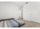 Bedroom with carpet, neutral walls, window, and ceiling lights and view into hallway at 1693 Barberry Dr, Kissimmee, FL 34744