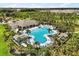 Stunning resort-style community pool with palm trees, cabanas, and plenty of lounge chairs for relaxation at 1693 Barberry Dr, Kissimmee, FL 34744