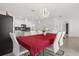 Open dining area with views of the kitchen with stainless appliances, white cabinets and granite counters at 1693 Barberry Dr, Kissimmee, FL 34744