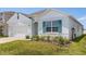 Charming single-Gathering home with turquoise shutters, well-kept lawn, and two car garage at 1693 Barberry Dr, Kissimmee, FL 34744