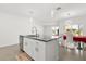 Kitchen island featuring granite countertops, double sinks, a dishwasher and stylish pendant lighting at 1693 Barberry Dr, Kissimmee, FL 34744