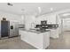 Modern kitchen with granite countertops, stainless steel appliances, white cabinetry and tile backsplash at 1693 Barberry Dr, Kissimmee, FL 34744