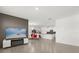 Open-concept living area with sleek tile floors, modern fireplace, and a clear view into the kitchen and dining space at 1693 Barberry Dr, Kissimmee, FL 34744
