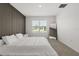 Main bedroom with stylish wall, carpet, a modern mirror, and a window with a view at 1693 Barberry Dr, Kissimmee, FL 34744