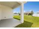 Covered patio with white column overlooking backyard with white vinyl fencing at 1693 Barberry Dr, Kissimmee, FL 34744
