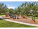 Community playground with multiple slides, climbing structures, and a soft landing surface for safety at 1693 Barberry Dr, Kissimmee, FL 34744