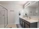 Modern bathroom featuring double sinks, sleek fixtures, and a glass-enclosed shower stall at 1836 Partin Terrace Rd, Kissimmee, FL 34744