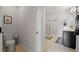 Well-lit bathroom featuring a toilet, glass-enclosed shower, and a modern vanity sink at 1836 Partin Terrace Rd, Kissimmee, FL 34744