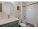 Charming bathroom featuring green vanity with gold hardware and a shower-tub combo at 1836 Partin Terrace Rd, Kissimmee, FL 34744