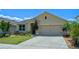 Charming single-story home with a well-manicured lawn and a two-car garage at 1836 Partin Terrace Rd, Kissimmee, FL 34744