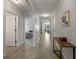 Bright hallway featuring wood-look flooring and an open view of the home's living spaces at 1836 Partin Terrace Rd, Kissimmee, FL 34744