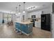 Open kitchen area with island, featuring quartz countertops and stainless-steel appliances at 1836 Partin Terrace Rd, Kissimmee, FL 34744
