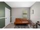 Cozy room with a leather futon, window with blinds, and unique decor, creating a welcoming space at 1836 Partin Terrace Rd, Kissimmee, FL 34744