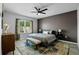 Comfortable main bedroom with a modern ceiling fan, bench seat, and a serene window view at 1836 Partin Terrace Rd, Kissimmee, FL 34744