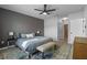 Comfortable main bedroom with a modern ceiling fan, bench seat, and a serene window view at 1836 Partin Terrace Rd, Kissimmee, FL 34744