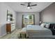 Comfortable main bedroom with modern ceiling fan, bench seat, and window bringing in natural light at 1836 Partin Terrace Rd, Kissimmee, FL 34744
