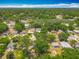 An aerial view of a neighborhood with lush tree coverage on a clear day at 1913 S Summerlin Ave, Sanford, FL 32771