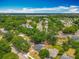 Expansive aerial view of a residential neighborhood with lush greenery and a serene lake nearby at 1913 S Summerlin Ave, Sanford, FL 32771