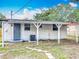 View of the backyard with a covered patio, lush lawn, storage shed, and perimeter fence, providing a private outdoor space at 1913 S Summerlin Ave, Sanford, FL 32771