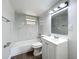 Bright bathroom with modern vanity, updated fixtures, and a shower-tub combination with beautiful white marble-look tile at 1913 S Summerlin Ave, Sanford, FL 32771