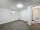 Bedroom featuring neutral paint, wood-look floors, and closet with view to adjoing bathroom at 1913 S Summerlin Ave, Sanford, FL 32771
