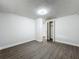 Bedroom showcasing wood-look flooring, neutral paint and a wide open closet with access to hall at 1913 S Summerlin Ave, Sanford, FL 32771