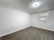 Cozy bedroom with wood-look flooring, neutral walls and a well lit window to the outside at 1913 S Summerlin Ave, Sanford, FL 32771