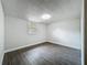 Spare bedroom with wood-look flooring, neutral paint, and a window to the backyard at 1913 S Summerlin Ave, Sanford, FL 32771