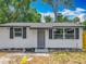 Charming single-story home with white siding, gray shutters, and a well-maintained front yard at 1913 S Summerlin Ave, Sanford, FL 32771
