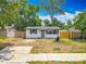 Cozy single-story home with white siding, a gray front door, and a small landscaped yard at 1913 S Summerlin Ave, Sanford, FL 32771