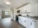 Bright kitchen with granite counters, white cabinetry and stainless appliances, open to the living area at 1913 S Summerlin Ave, Sanford, FL 32771