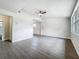 Bright living room with wood-look floors, ceiling fan, and access to other rooms at 1913 S Summerlin Ave, Sanford, FL 32771