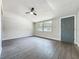 Living room featuring wood-look floors, a ceiling fan, and a gray front door at 1913 S Summerlin Ave, Sanford, FL 32771