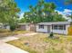 View of a single-story home and yard with mature tree, shed, and partial wood fencing at 1913 S Summerlin Ave, Sanford, FL 32771