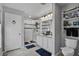 Well-lit bathroom features a glass enclosed shower, double sink vanity, and tiled floor at 208 Summerlin Ln, Haines City, FL 33844