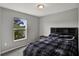 Cozy bedroom features a window and neutral tones that fills the space with natural light at 208 Summerlin Ln, Haines City, FL 33844