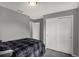 This bedroom features a gray wall color with a black and gray bed set and white closet doors at 208 Summerlin Ln, Haines City, FL 33844