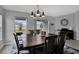 Elegant dining space with a classic chandelier, table, and views of the backyard at 208 Summerlin Ln, Haines City, FL 33844