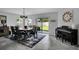 Inviting dining area with a wooden table, chandelier, and natural light, perfect for Gathering meals at 208 Summerlin Ln, Haines City, FL 33844