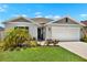 Charming single-Gathering home with a well-manicured lawn and a two-car garage in a suburban neighborhood at 208 Summerlin Ln, Haines City, FL 33844