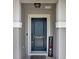 Close-up of an inviting front door with a decorative 'Welcome' sign and elegant door hardware at 208 Summerlin Ln, Haines City, FL 33844