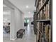 Hallway with tiled floor, adjacent to a bedroom and a built in bookshelf along a wall at 208 Summerlin Ln, Haines City, FL 33844