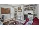 Bright home office featuring a large bookshelf, a workstation and a comfortable red couch at 208 Summerlin Ln, Haines City, FL 33844